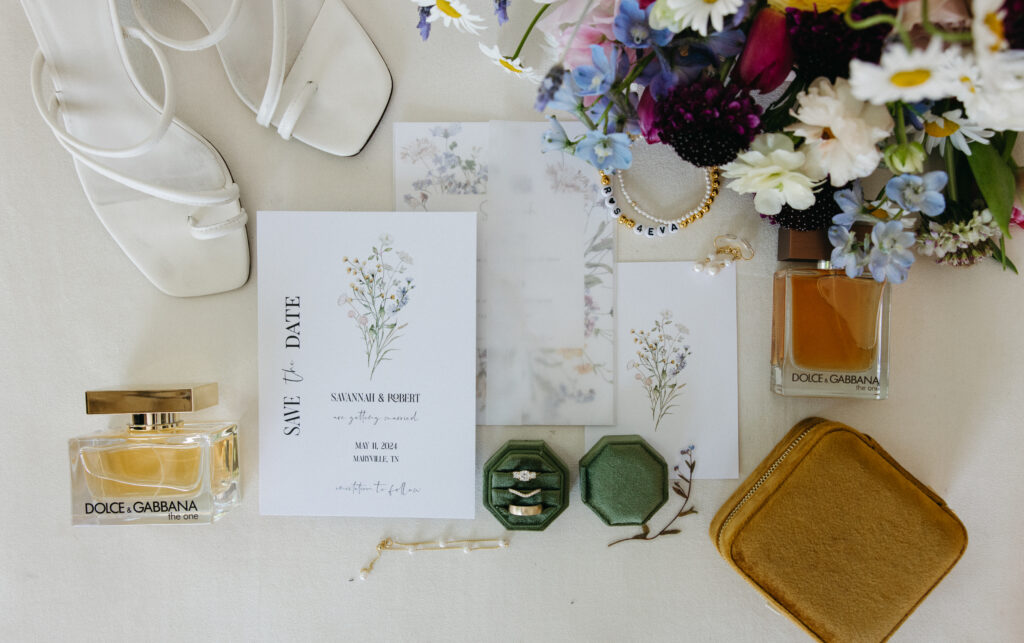 Flat lay wedding photography. DIY Invites, pop of color wedding florals, his and her details. Wedding Shoes, Wedding Cologne and perfume.