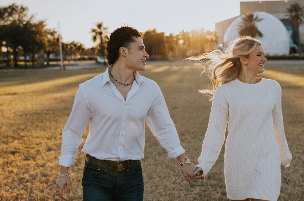 Couple running off in to the sunset 