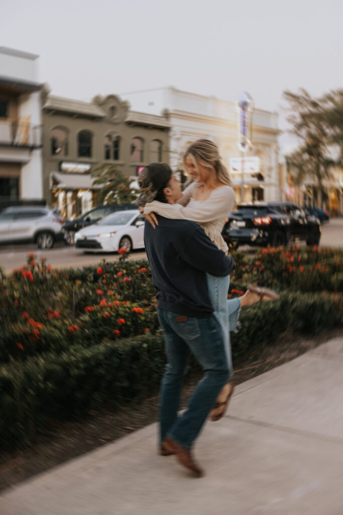 Couple spinning around for engagement photos