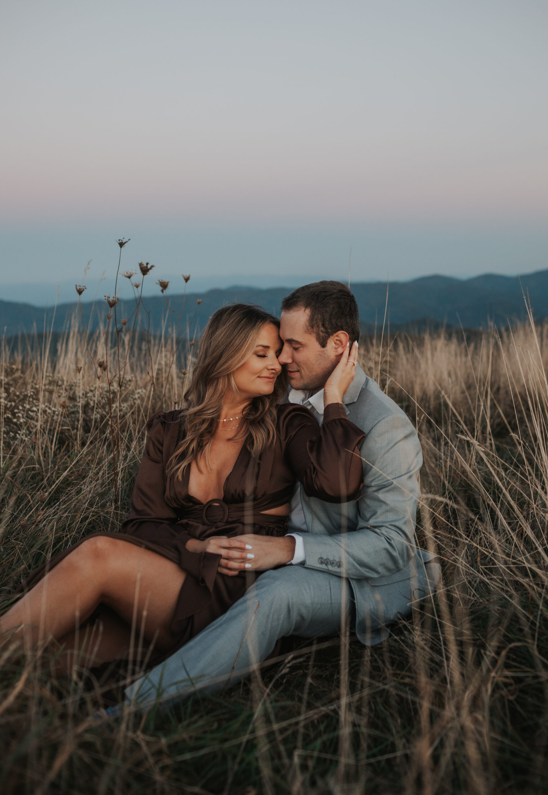 couple cuddled together for engagement photos