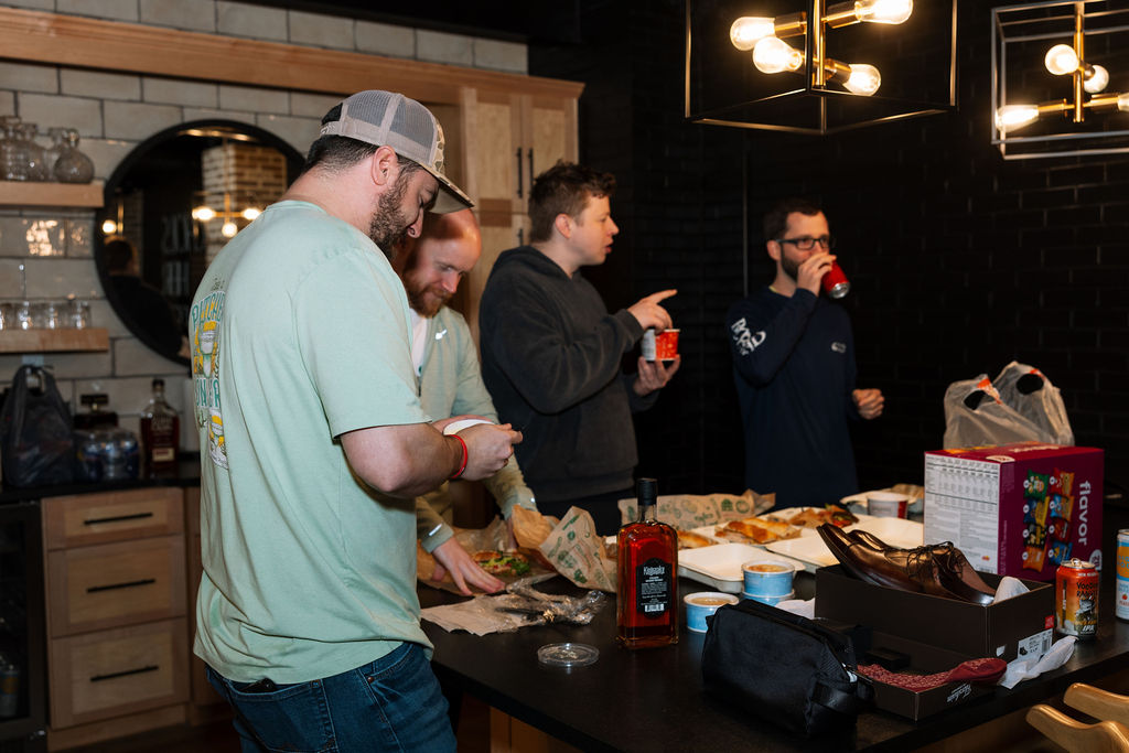 Groomsmen gathering in the kitchen during wedding morning preparations, relaxed start to a planner-supported Tennessee wedding day.