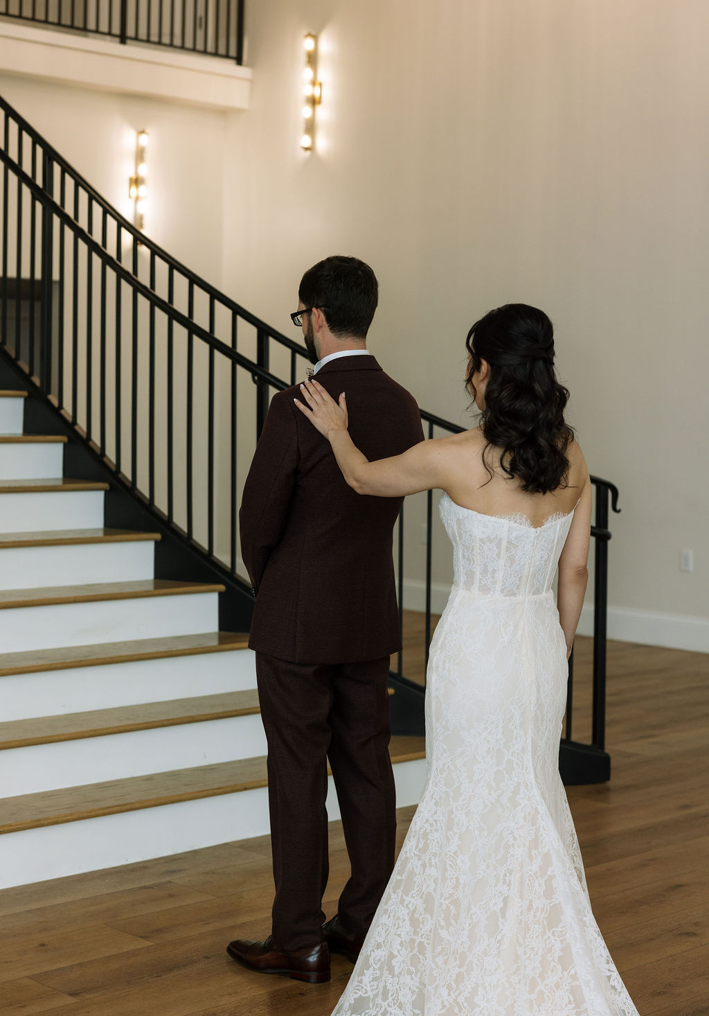 Bride tapping groom’s shoulder for a first look inside Nichols Heir, an intentional timeline moment that reflects what do wedding planners do to protect meaningful transitions.