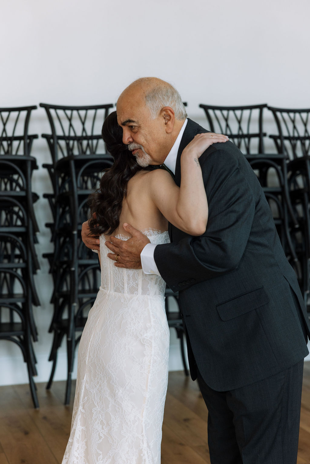 Father embracing bride before walking down the aisle, intimate indoor moment during a thoughtfully coordinated Tennessee wedding day.