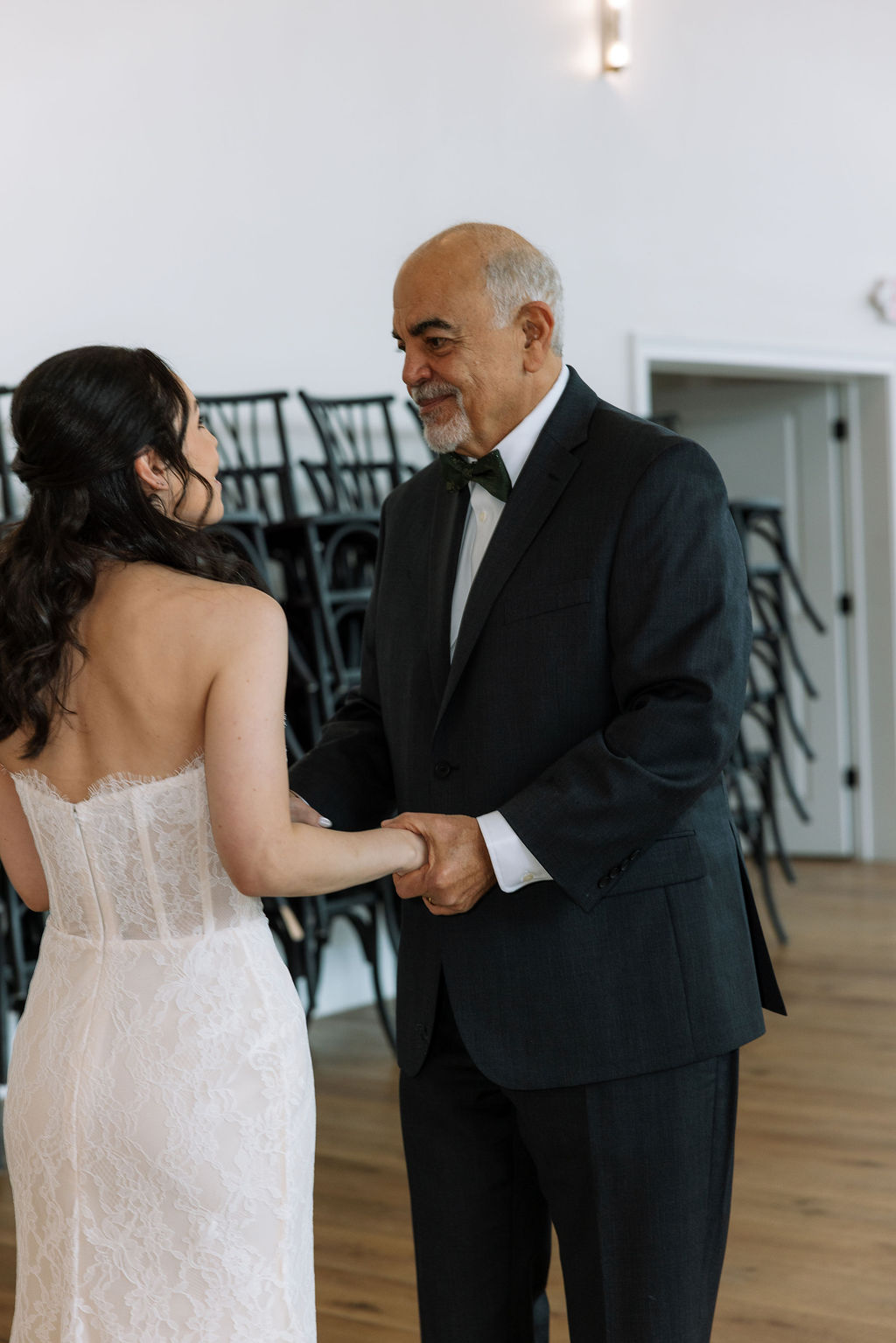 Bride holding hands with her father before the ceremony, a steady pre-ceremony moment that shows what do wedding planners do to keep family transitions calm and unrushed.