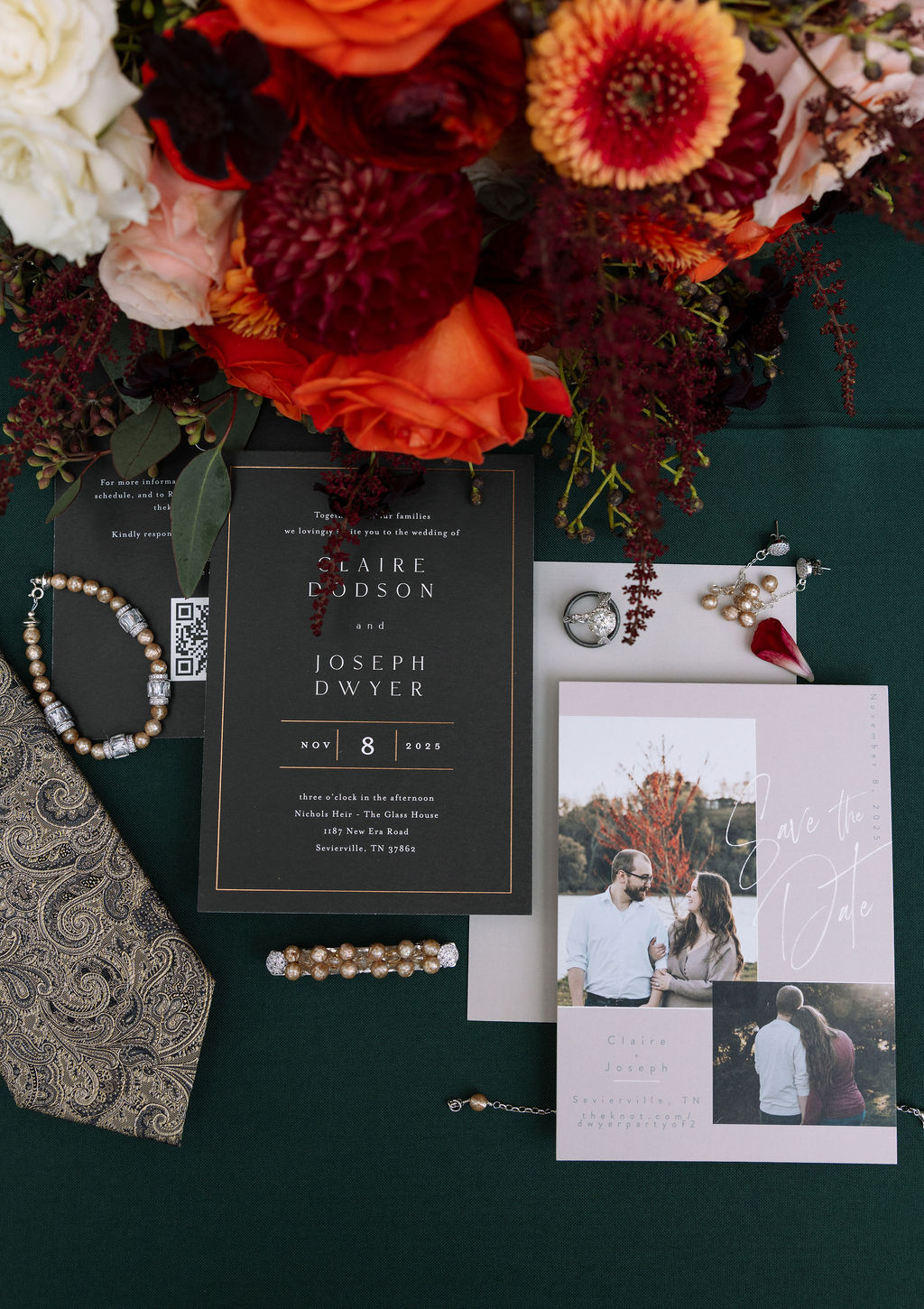 Wedding flat lay with flowers and bridal accessories showcasing their beautiful wedding invitations. 