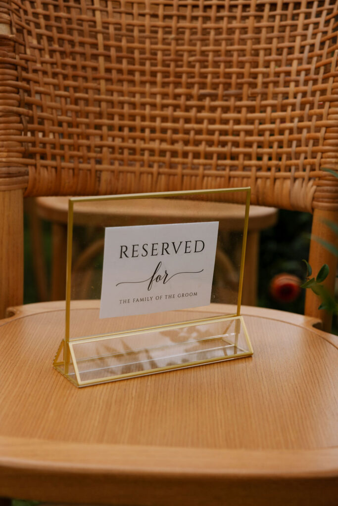 Reserved family seating sign displayed on a wooden chair as part of a thoughtfully styled wedding ceremony setup.