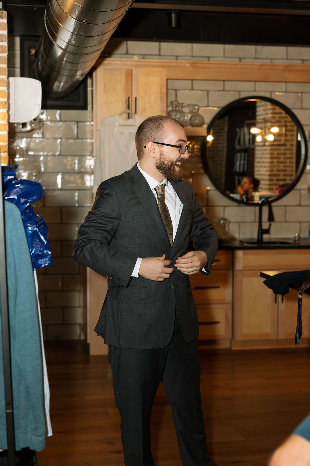 Groom buttoning jacket before going into wedding ceremony at Smoky Mountain wedding venue