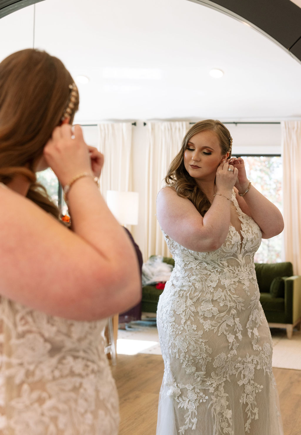 Bride putting on earrings before walking down to her wedding ceremony at smoky mountain wedding venue. 