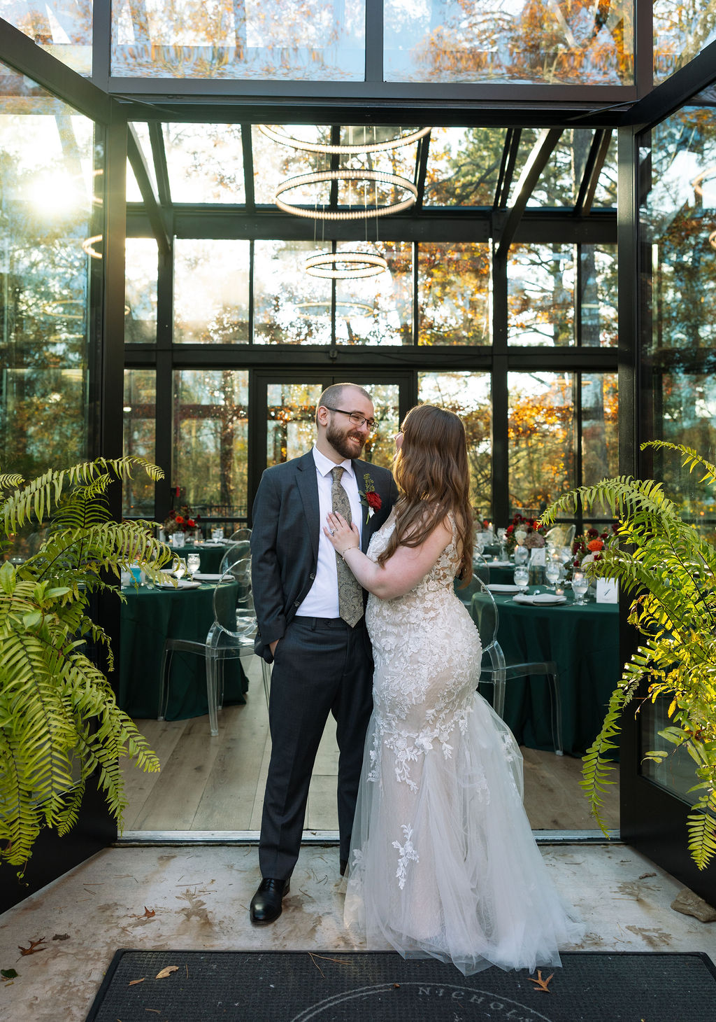 Couple embracing in Glass House at Nichols Heir, a Smoky Mountain wedding venue. 