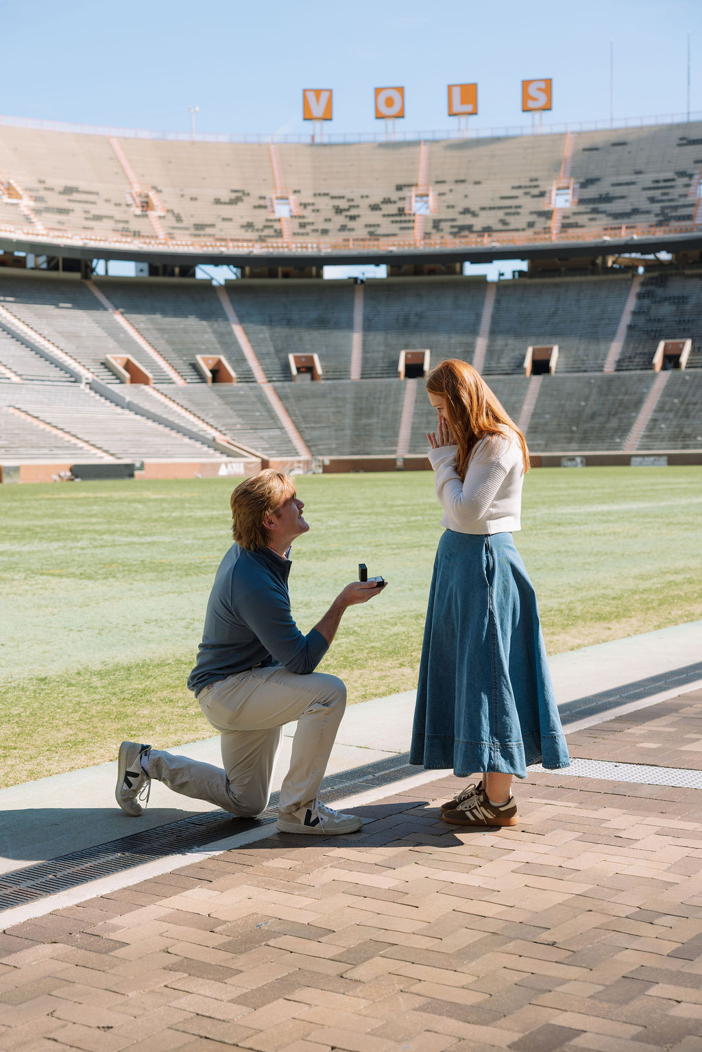 Emotional reaction as woman realizes surprise proposal at Neyland Stadium in Knoxville
