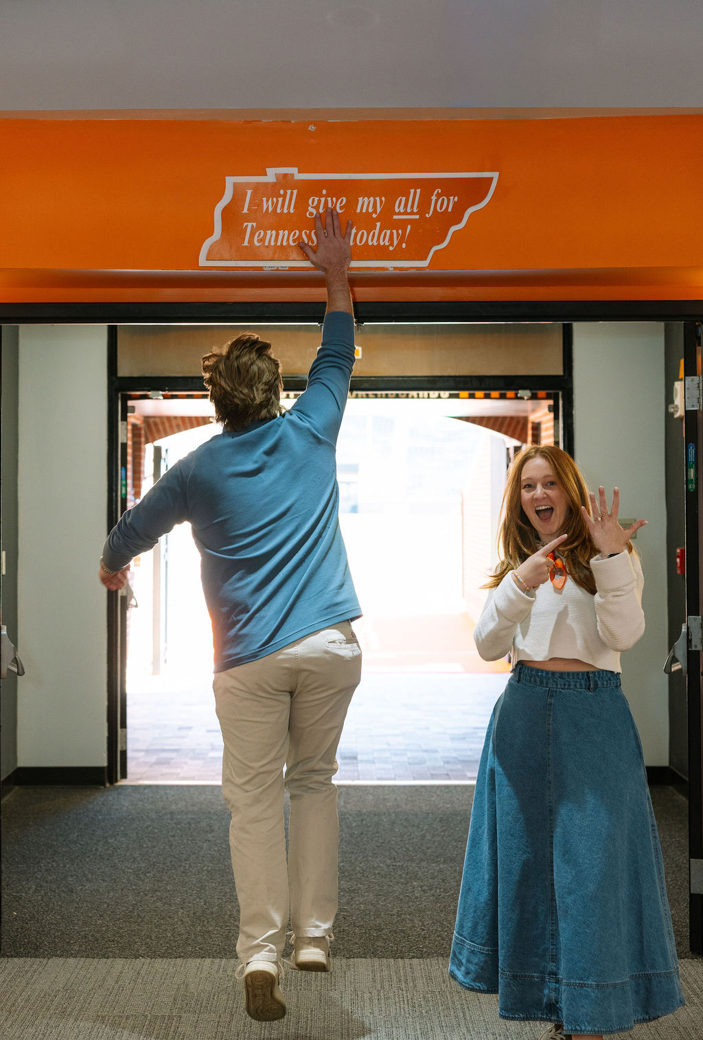 Woman showing engagement ring after surprise proposal at Neyland Stadium tunnel