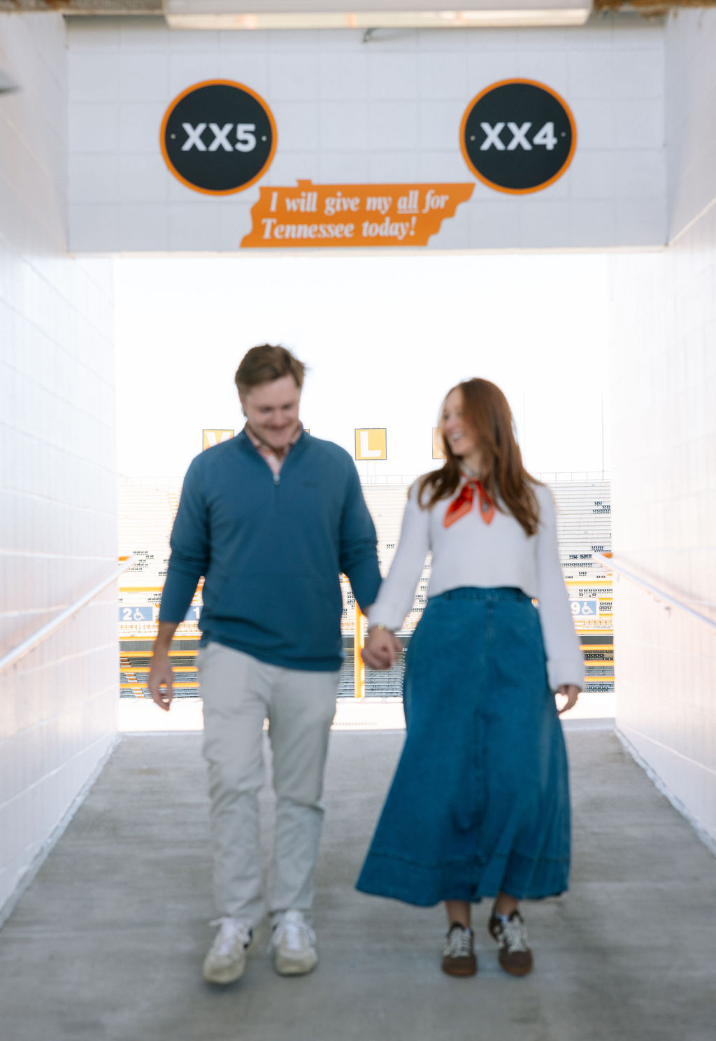 Couple walking through Neyland Stadium tunnel after surprise proposal at University of Tennessee