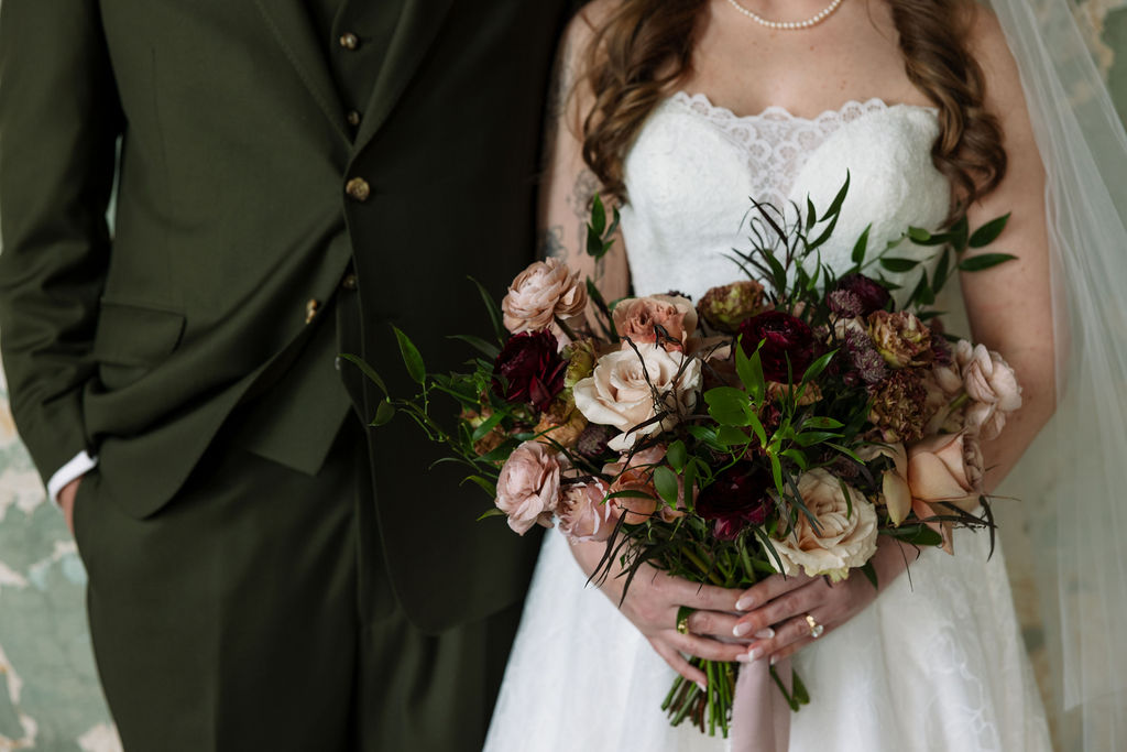 Close-up of bride holding a romantic, textured bouquet with soft neutral and deep tones, photographed by a wedding photographer in Knoxville