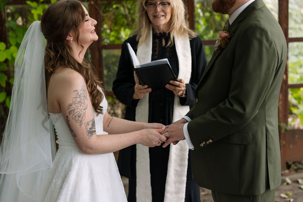 Bride placing a ring on groom’s hand during the ceremony, captured by a wedding photographer in Knoxville