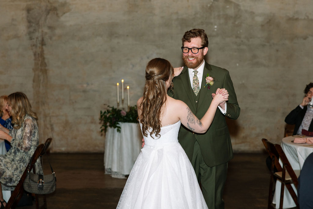Bride and groom sharing their first dance in a softly lit reception space, captured by a wedding photographer in Knoxville