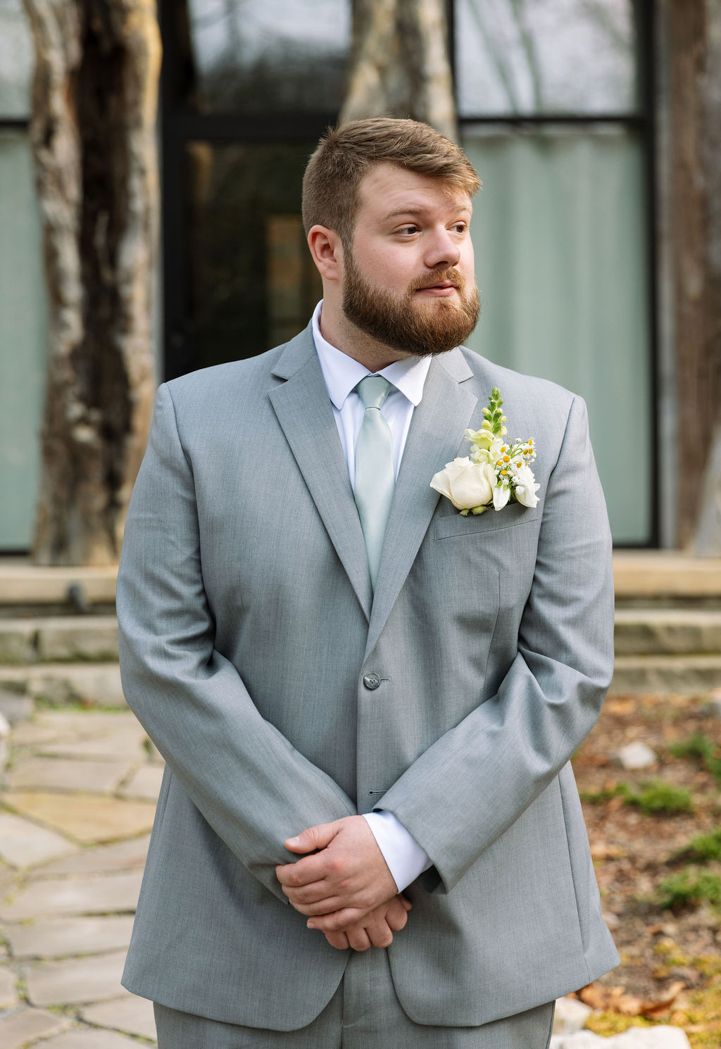Groom waiting before ceremony outside Tennessee wedding venue captured in candid wedding photography