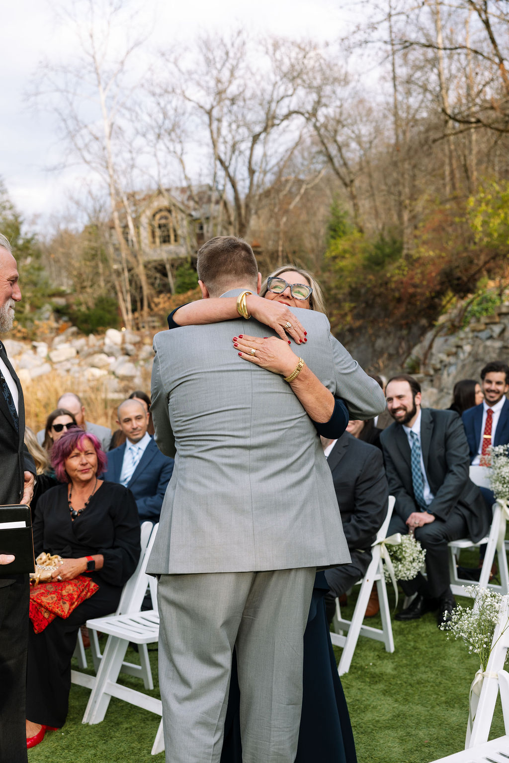 Emotional hug during outdoor ceremony captured through candid wedding photography at Tennessee wedding