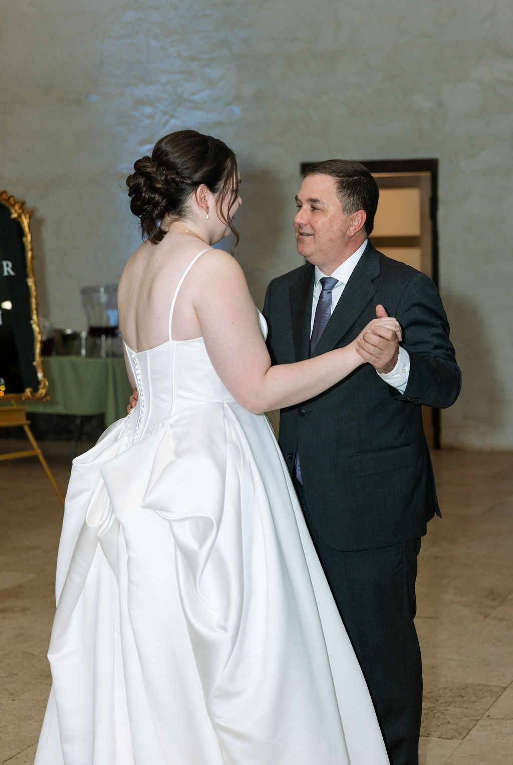 Bride dancing with father during heartfelt wedding reception dance