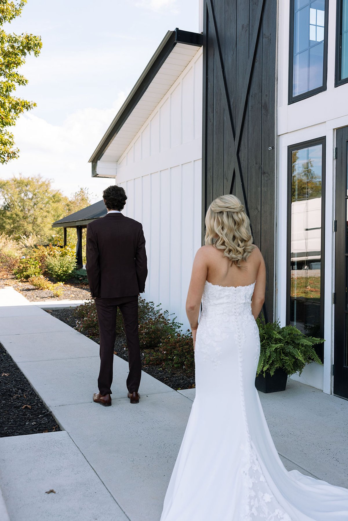 Tennessee wedding first look moment outside modern white barn venue