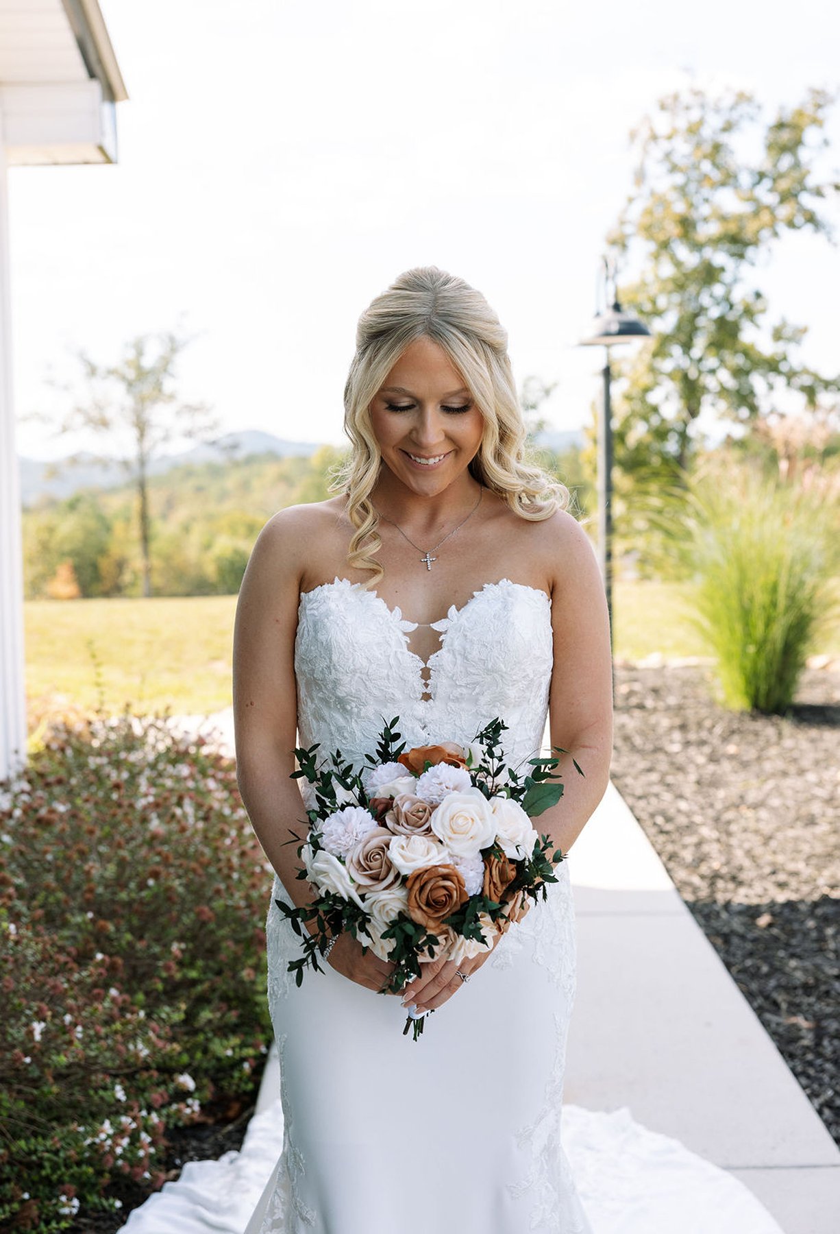 Tennessee wedding bride holding bouquet, looking down in soft morning light