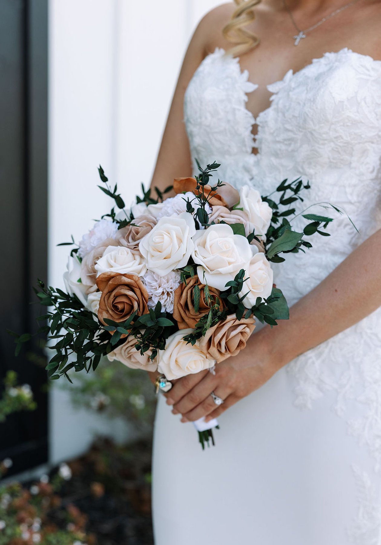 Bridal bouquet with neutral roses and greenery close-up detail