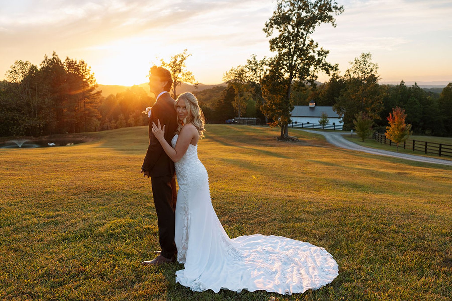 Tennessee wedding sunset portrait with bride resting against groom in open field