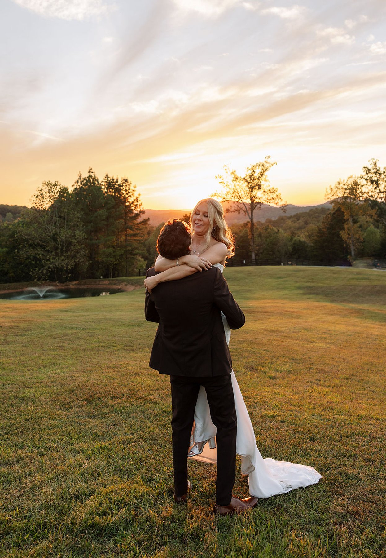 Tennessee wedding couple embracing in open field at golden sunset