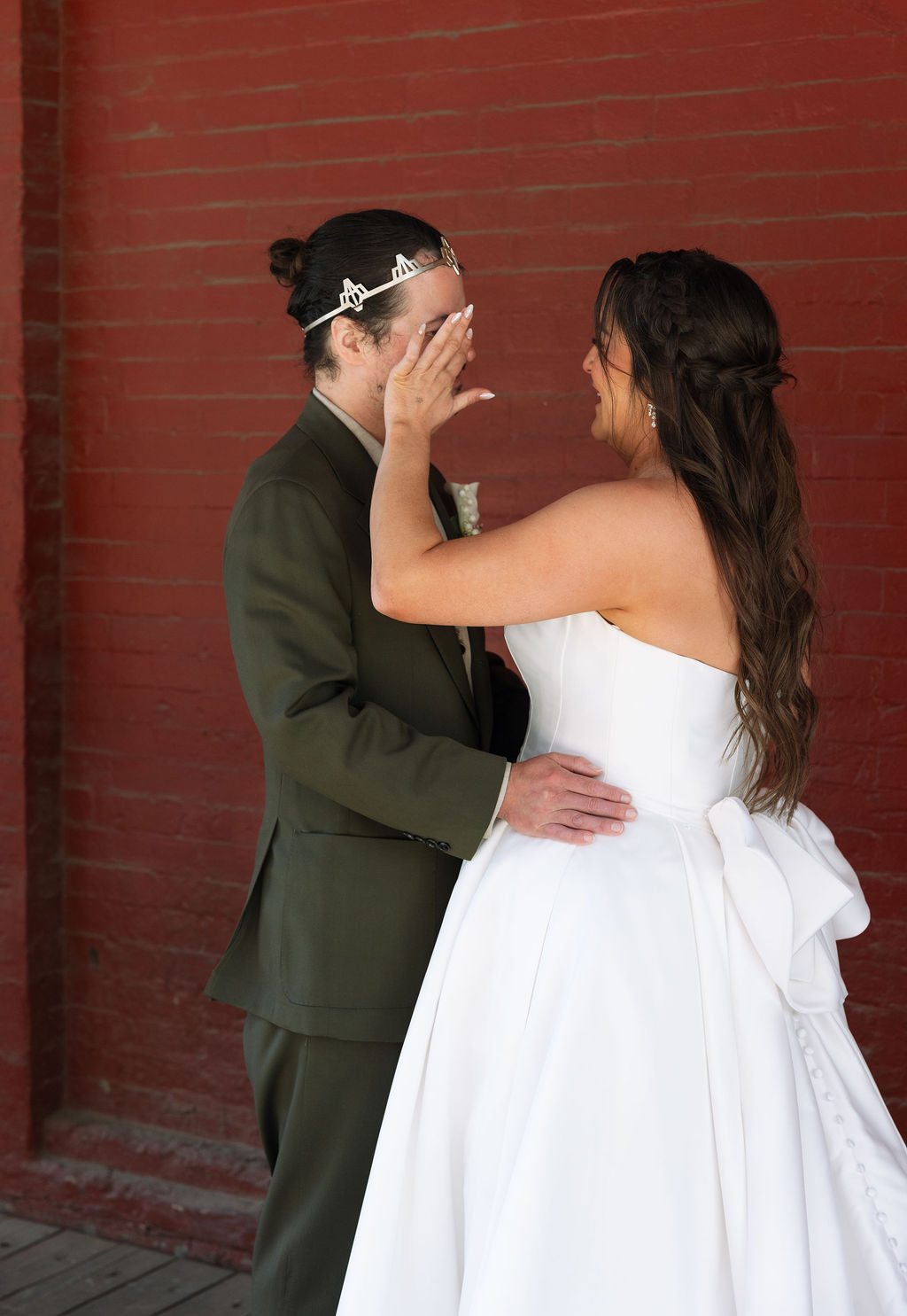 Bride wiping groom’s face during emotional first look moment at Jackson Terminal Knoxville