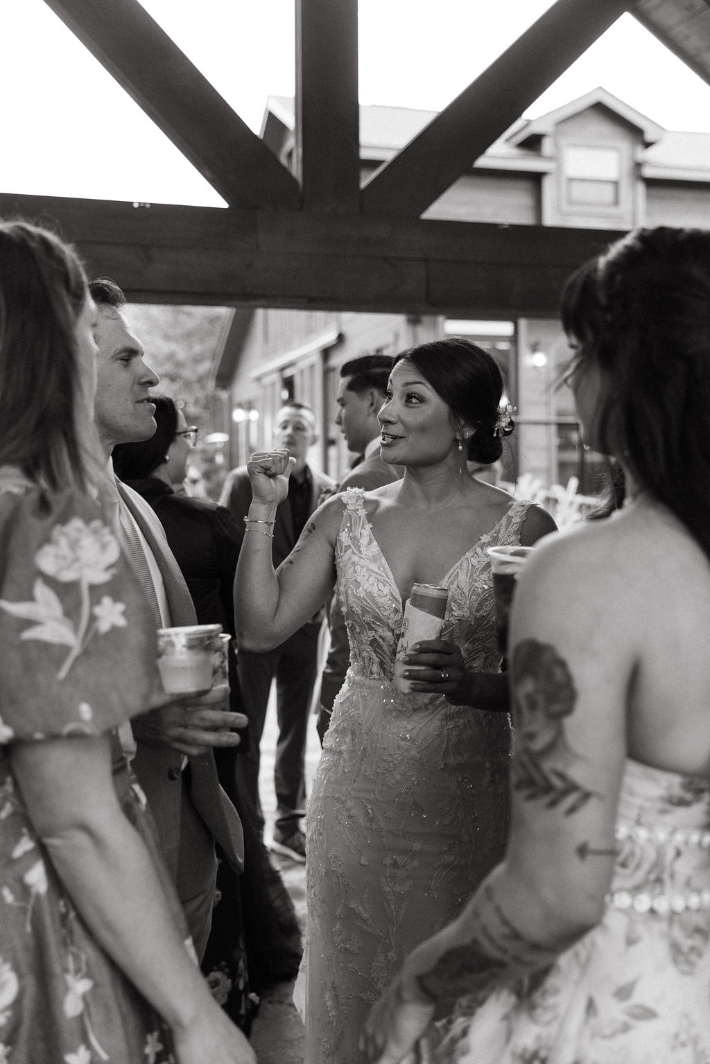 Bride talking with guests during cocktail hour inside the reception space at The Magnolia Wedding Venue
