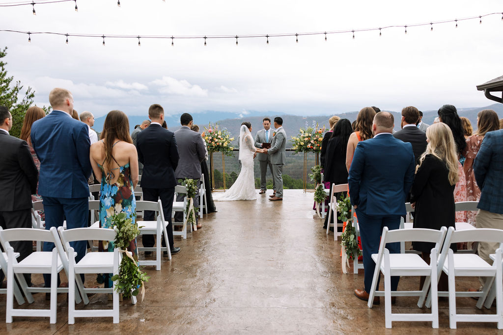 Wide view of ceremony at The Magnolia Wedding Venue with guests seated and mountain views in the background

