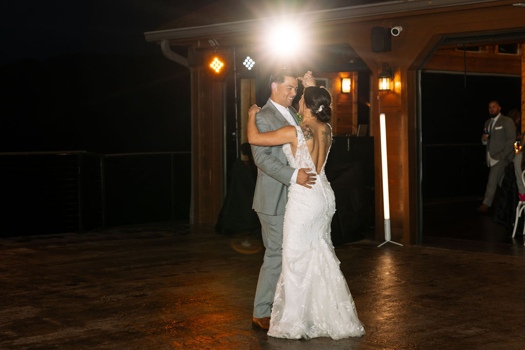 Bride and groom sharing a first dance on the outdoor patio at The Magnolia Wedding Venue
