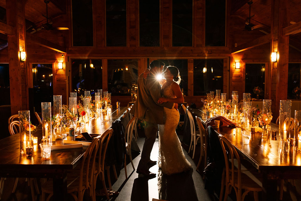 Backlit silhouette of bride and groom during their first dance at The Magnolia Wedding Venue

