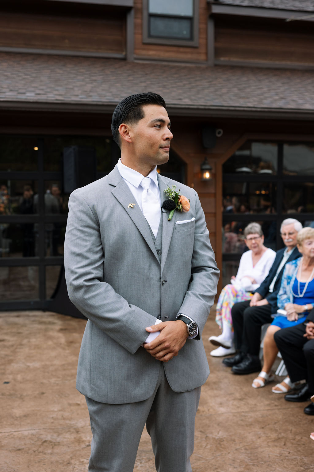 Groom standing at the altar waiting for the ceremony to begin at The Magnolia Wedding Venue
