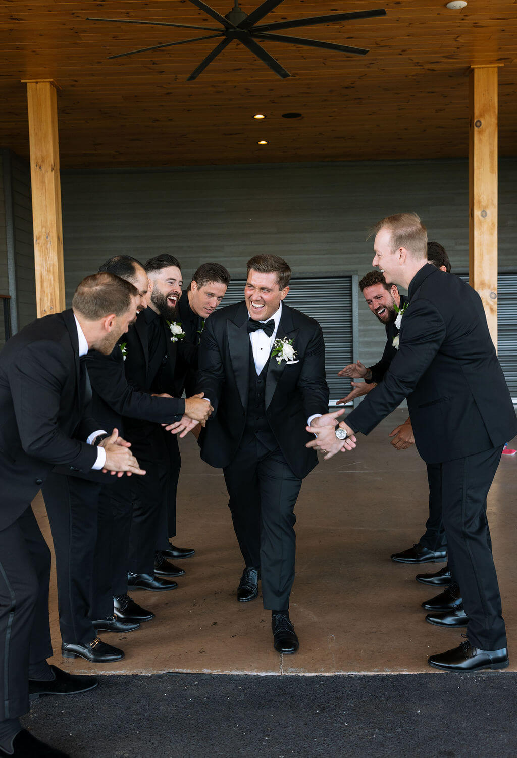 Groom laughing with groomsmen before ceremony at a Knoxville wedding venue