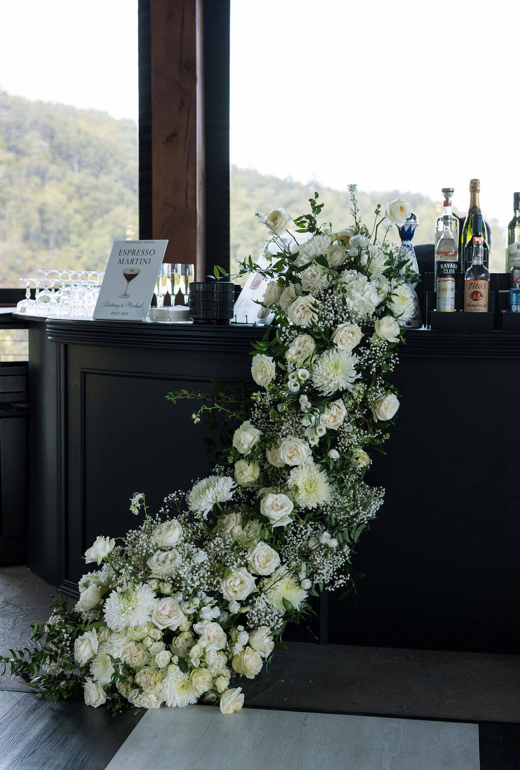 White floral ceremony installation with cascading roses at a Knoxville wedding venue