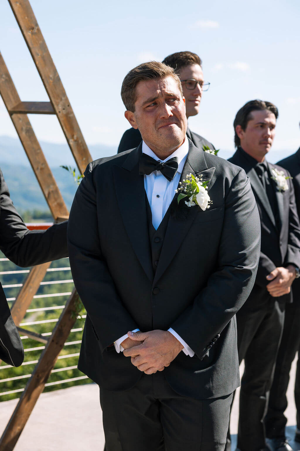 Emotional groom waiting for bride during outdoor wedding ceremony at a Knoxville wedding venue