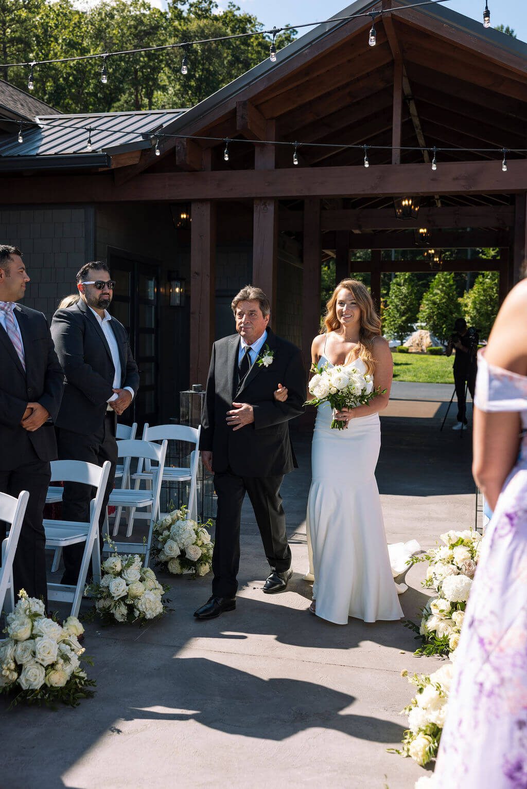 Bride walking down the aisle with her father at a Knoxville wedding venue