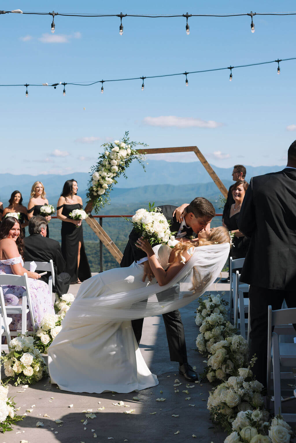 Bride and groom dip kiss during ceremony recessional at a Knoxville wedding venue
