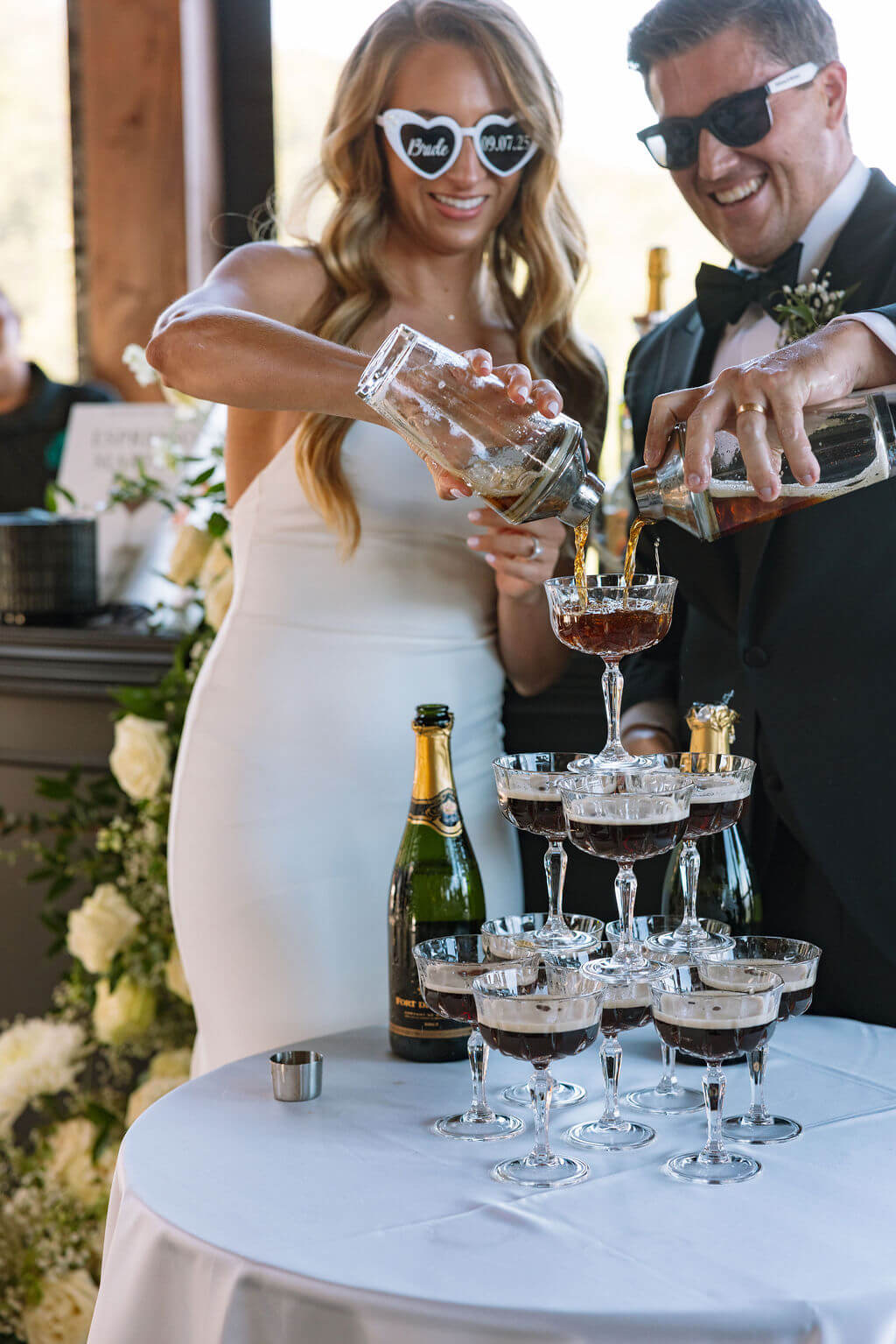 Bride and groom making espresso martinis during wedding reception