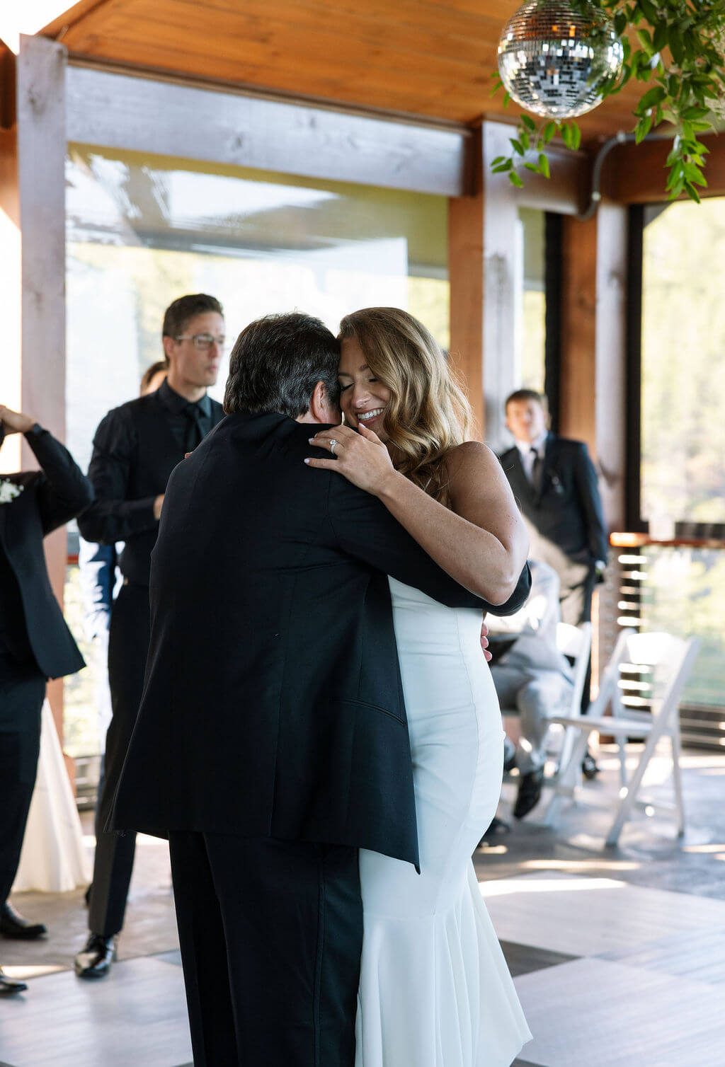 Bride hugging father during wedding reception at a Knoxville wedding venue