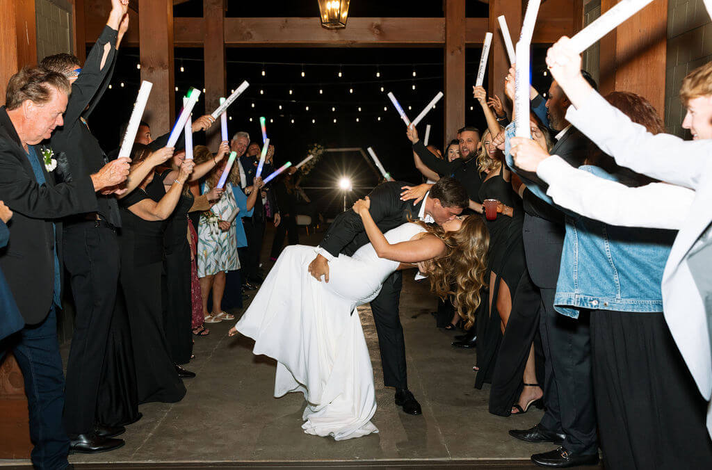 Bride and groom kissing during glow stick exit at a Knoxville wedding venue