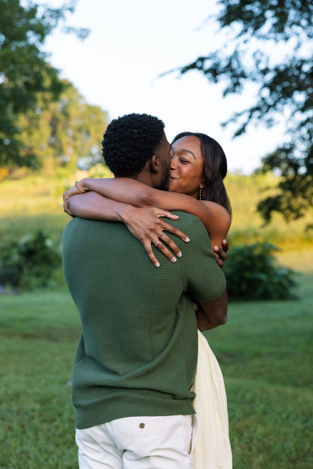 Couple hugging after a proposal during a Knoxville, Tennessee engagement session at sunset.