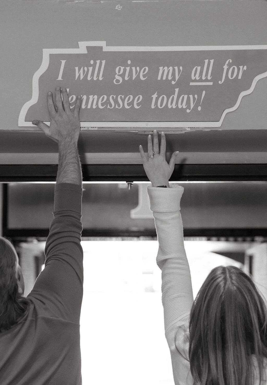 Black and white photo of fans holding a Tennessee sign during a Knoxville, Tennessee proposal session at Neyland Stadium.