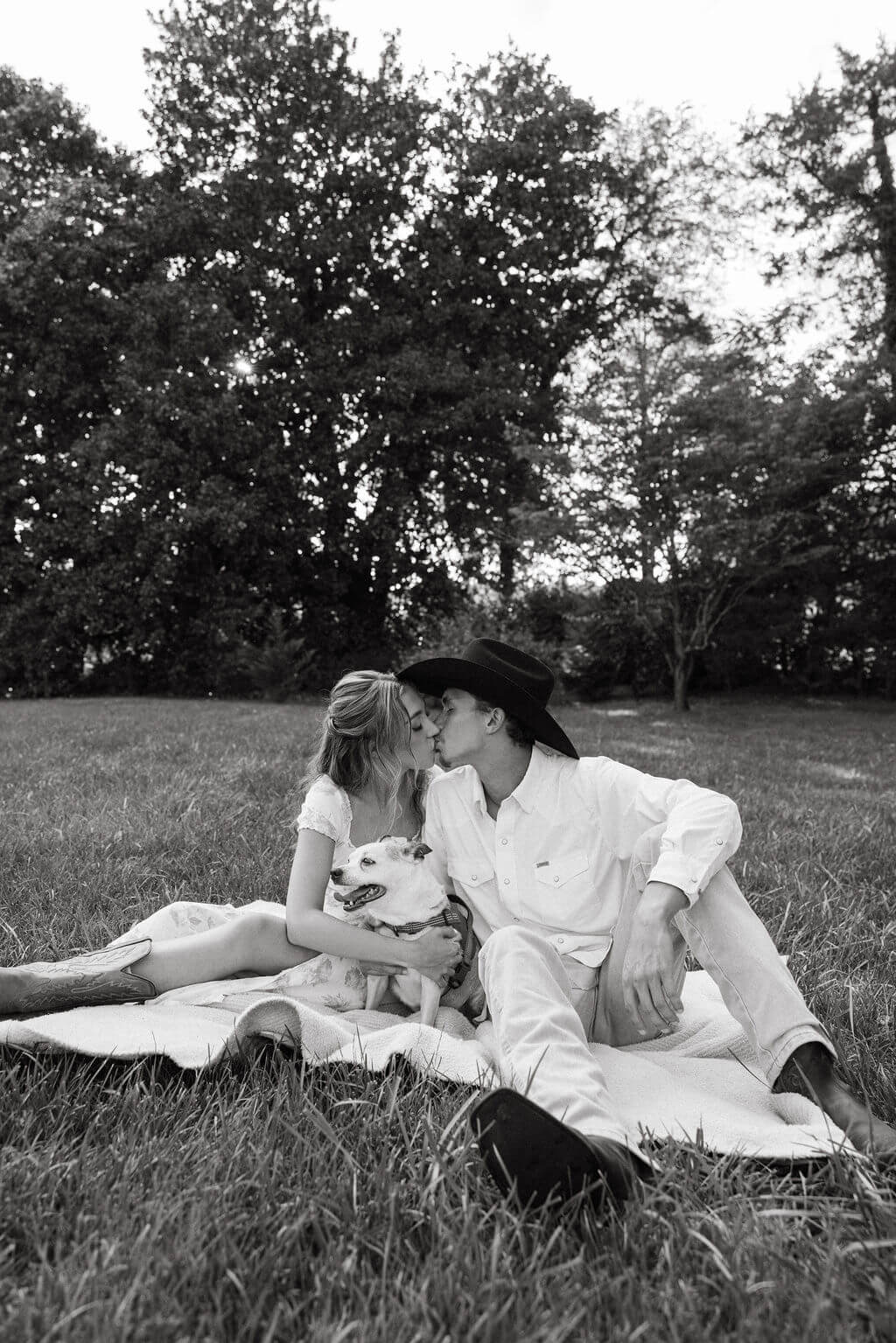 Black and white engagement photos with couple relaxing on a blanket at Maple Grove Estate