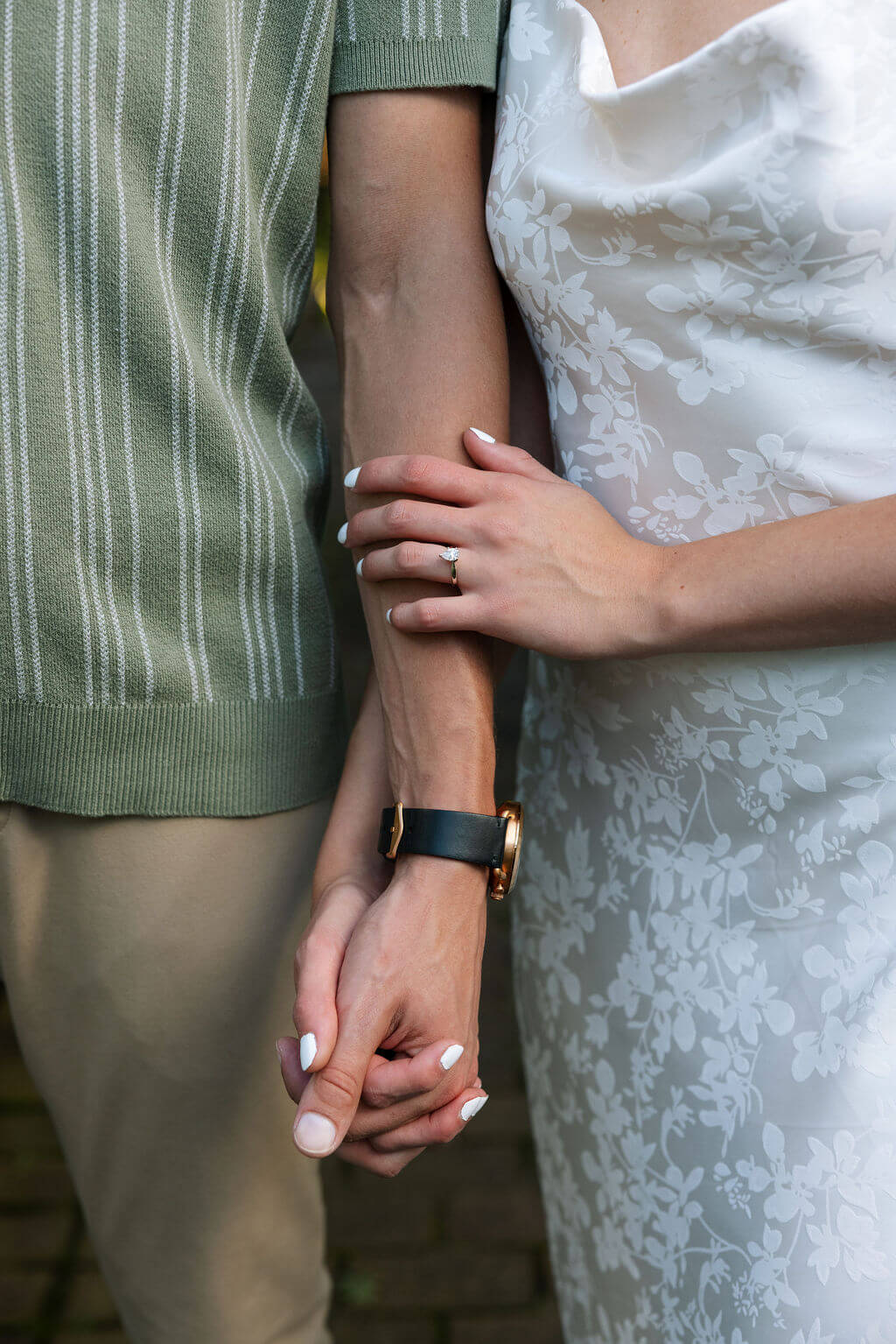 Detail photo of couple holding hands during a romantic Maple Grove Estate engagement session