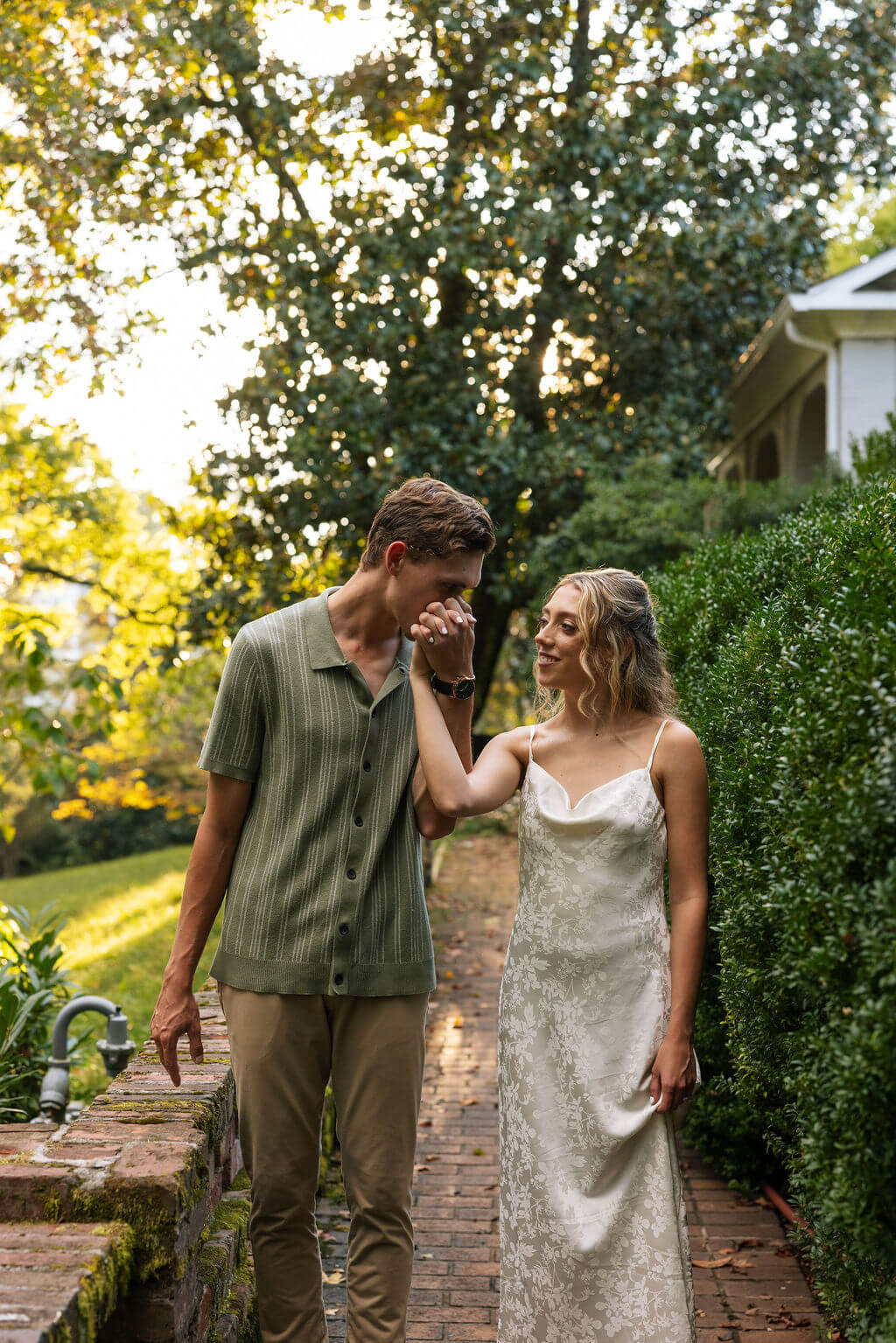 Golden hour engagement portraits at Maple Grove Estate with couple walking through the gardens