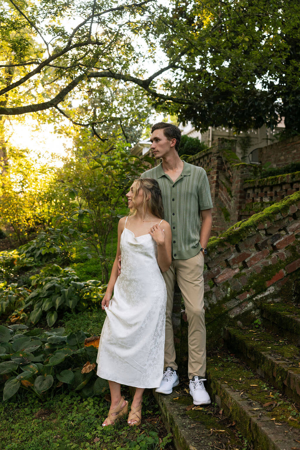 Romantic golden hour engagement portraits near ivy covered brick walls at Maple Grove Estate