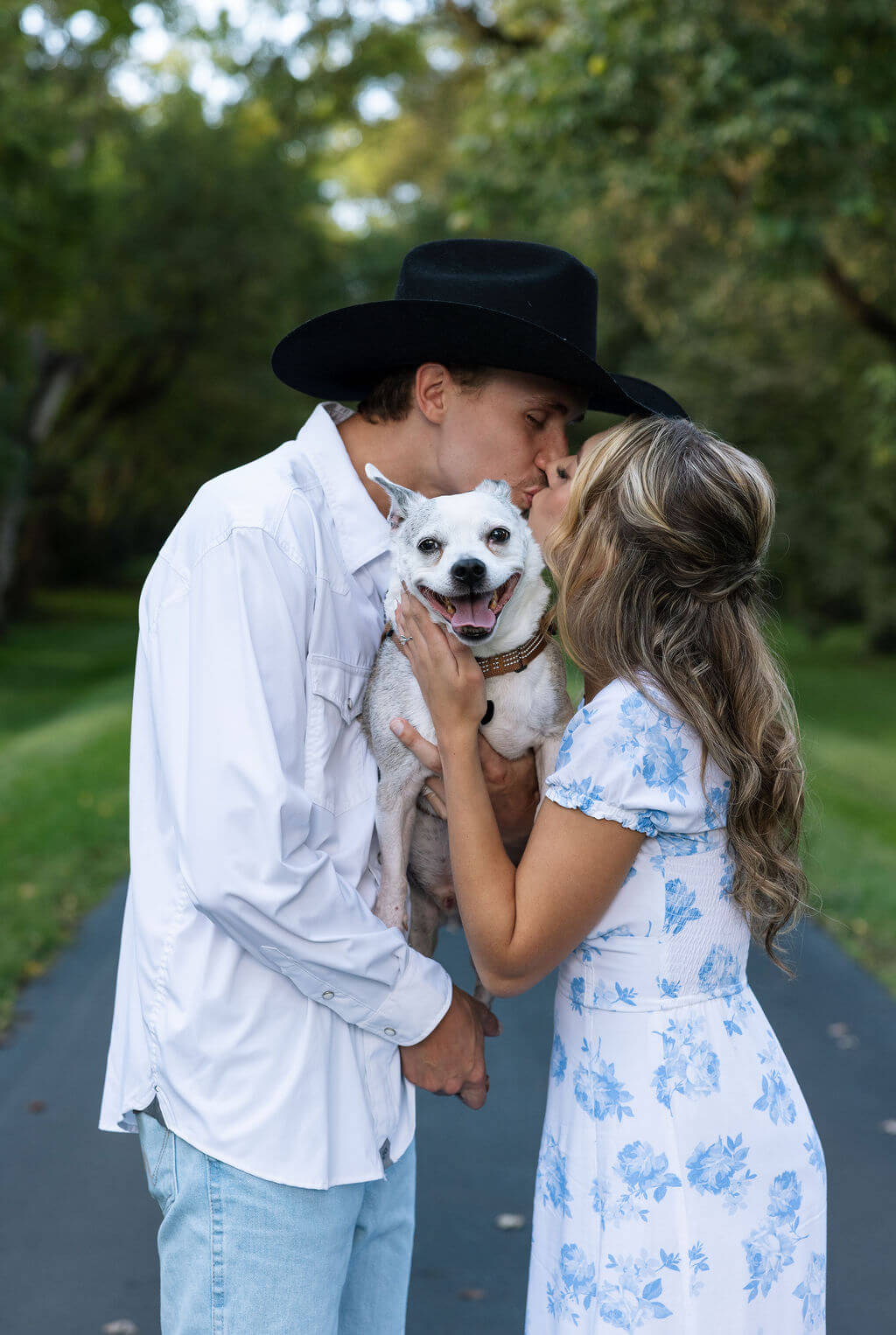 Couple holding their dog during a Maple Grove Estate engagement photoshoot