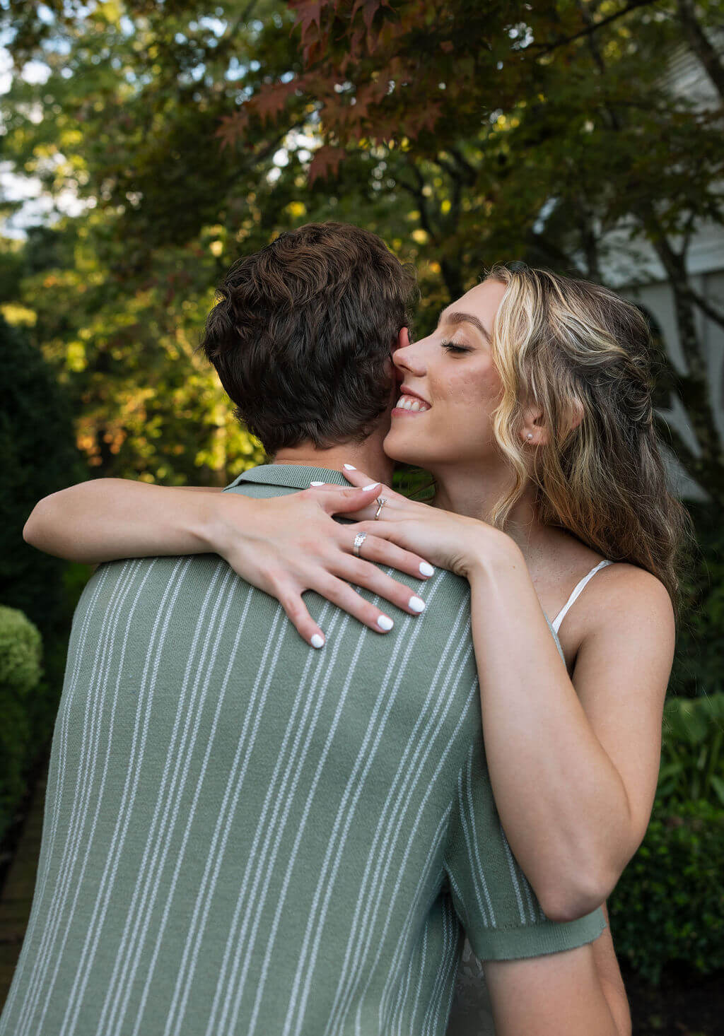 Close up engagement portrait at Maple Grove Estate with bride embracing her fiancé