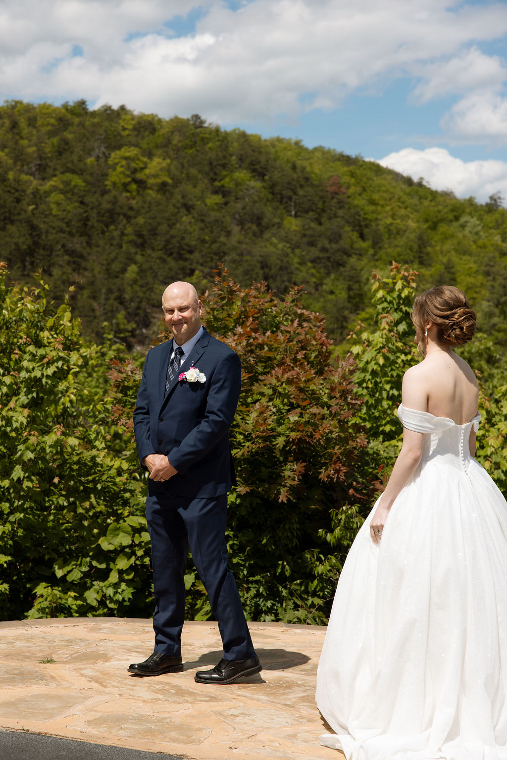 Bride approaching her father for an emotional first look with Smoky Mountain views at a Sevierville wedding venue